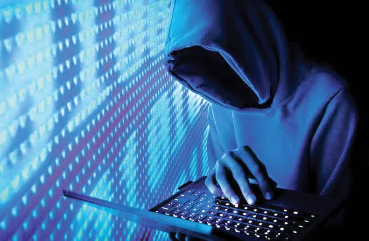 A Dubai Police officer at the Anti-Fraud Centre reviewing financial tracking data related to cybercrime cases targeting university students.
