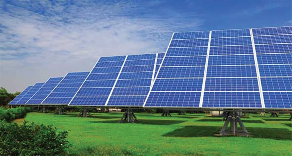 A large array of solar panels in a desert environment, representing the UAE's solar energy projects.