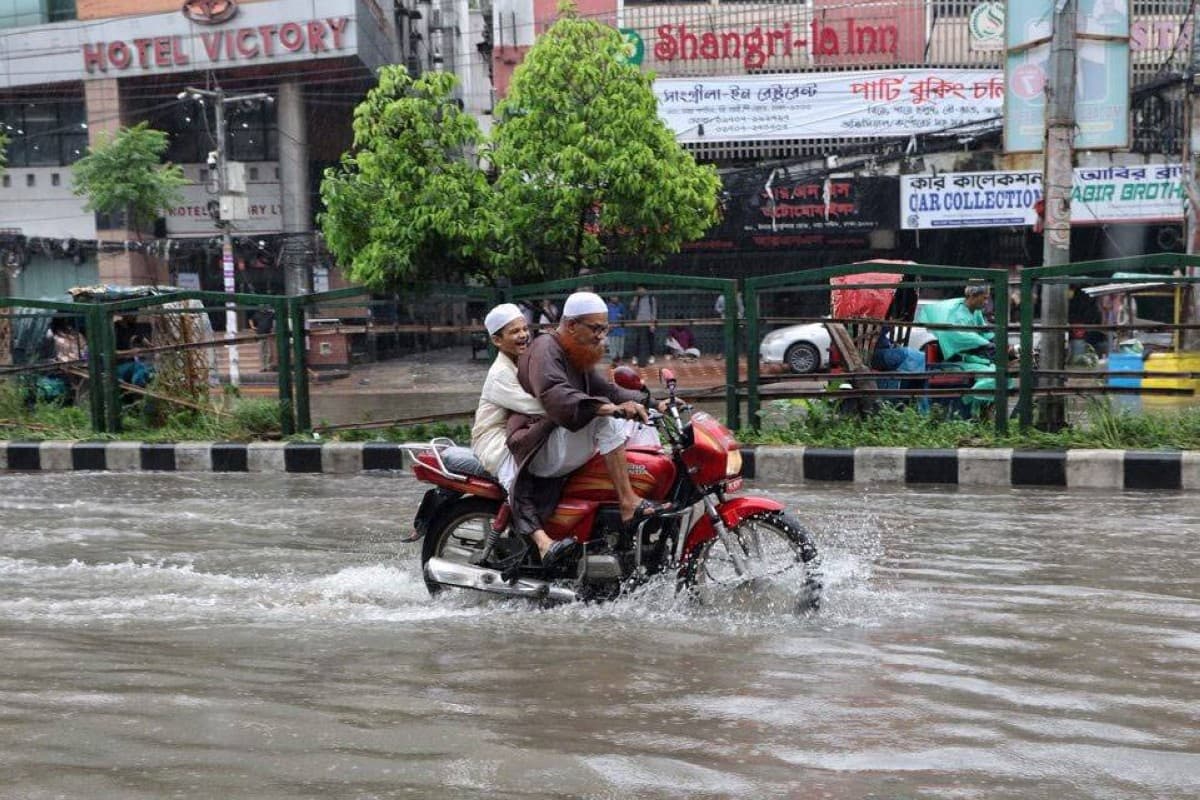 Floodwaters inundate a residential area in south-eastern Bangladesh as displaced residents wade through the streets following heavy monsoon rains.