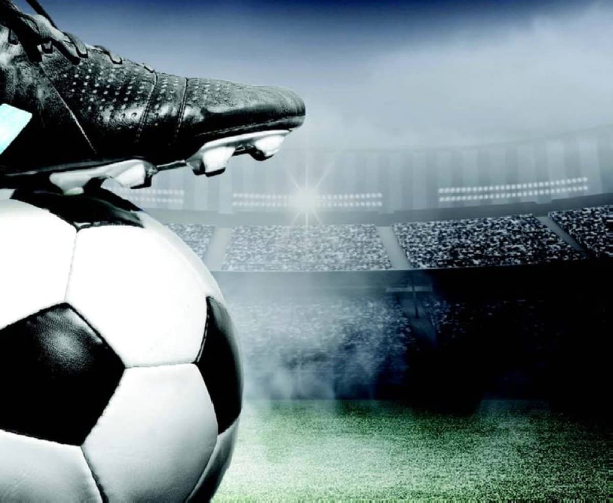 A footballer heading a ball during a match, illustrating research into the neurological effects of repeated head impacts.