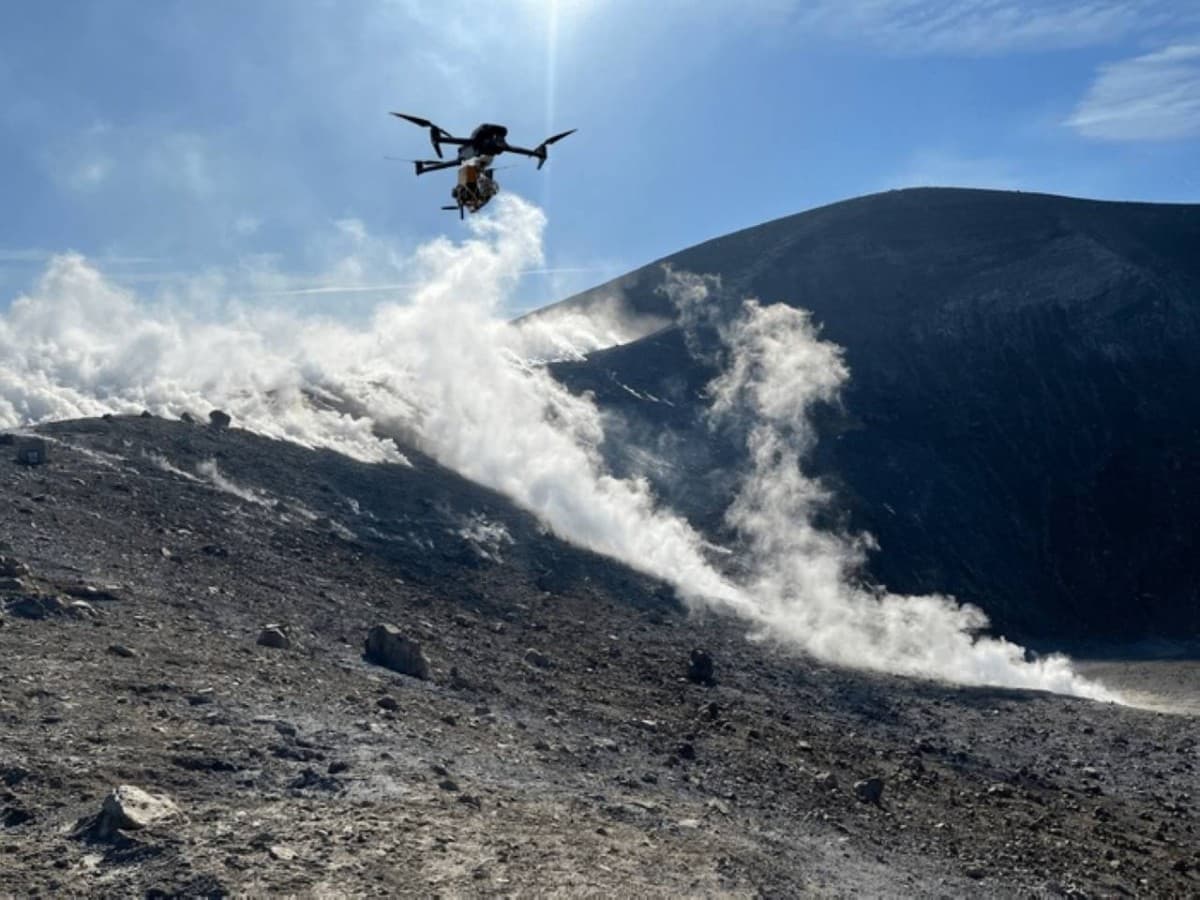 A drone flies above the crater rim of the volcanic island of Vulcano near Sicily as part of a German research team's laser-based system for measuring volcanic gases.