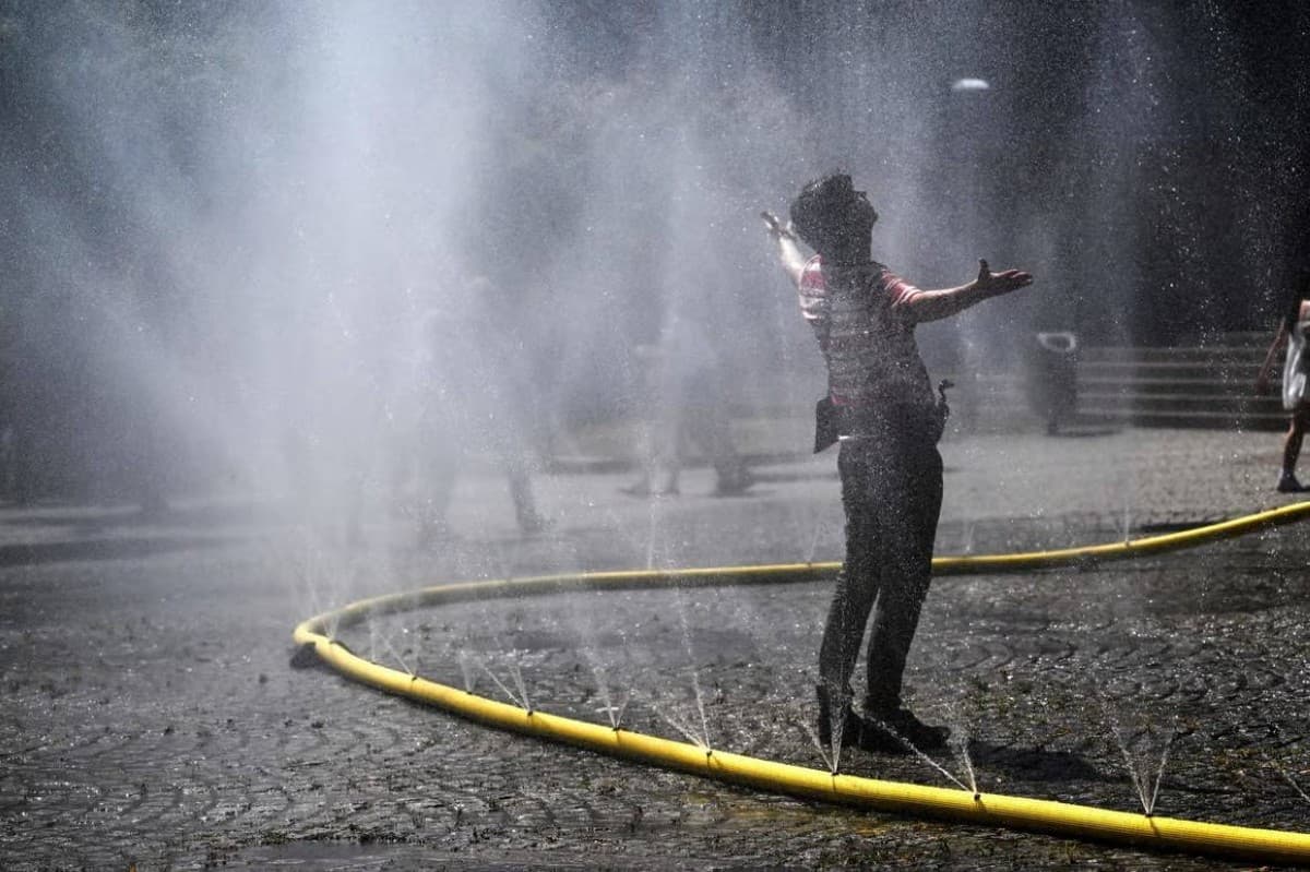 Crowds of people seeking shade and shelter during a record-breaking heatwave in western Europe.