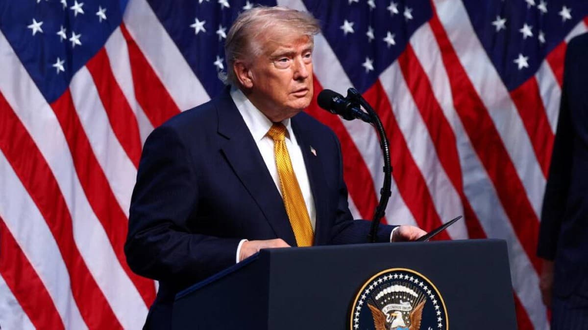 US President Donald Trump speaking at a podium during a televised national address.
