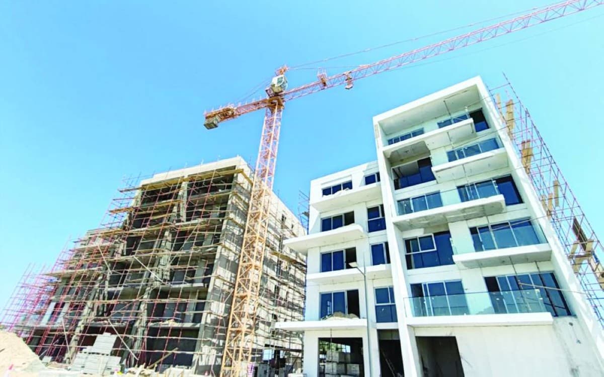 A construction site in Dubai with high-rise buildings under development against an urban skyline.