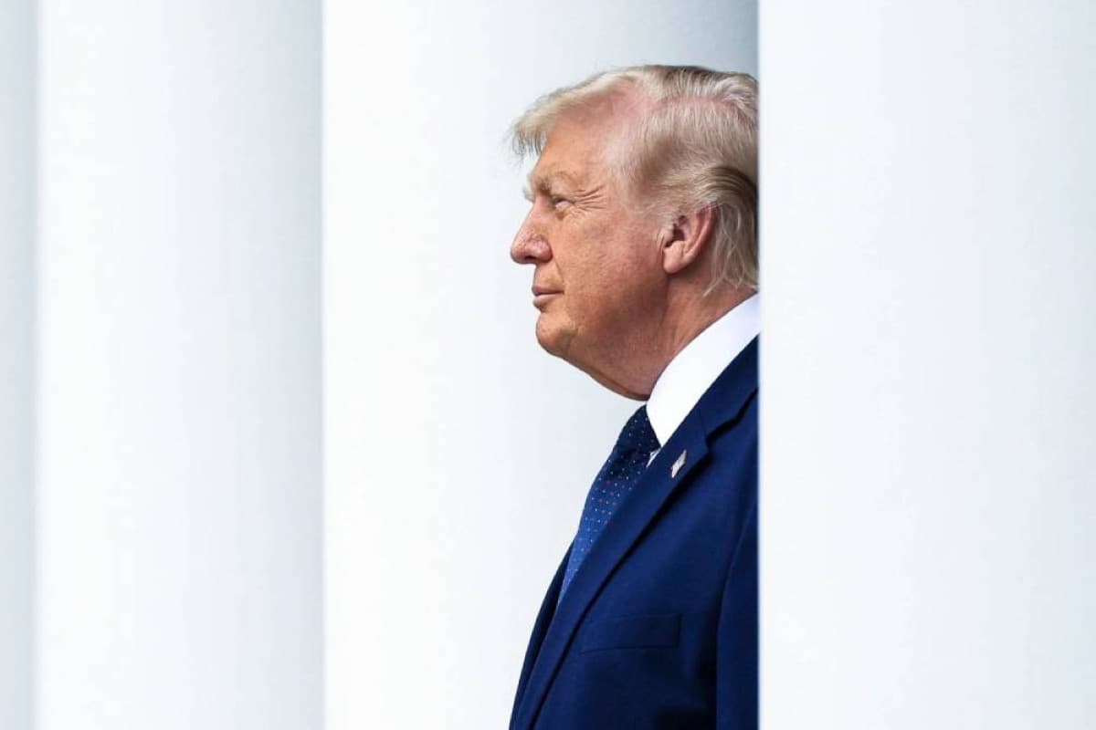 US President Donald Trump speaking during a television interview, with imagery related to Iran's nuclear programme in the background.