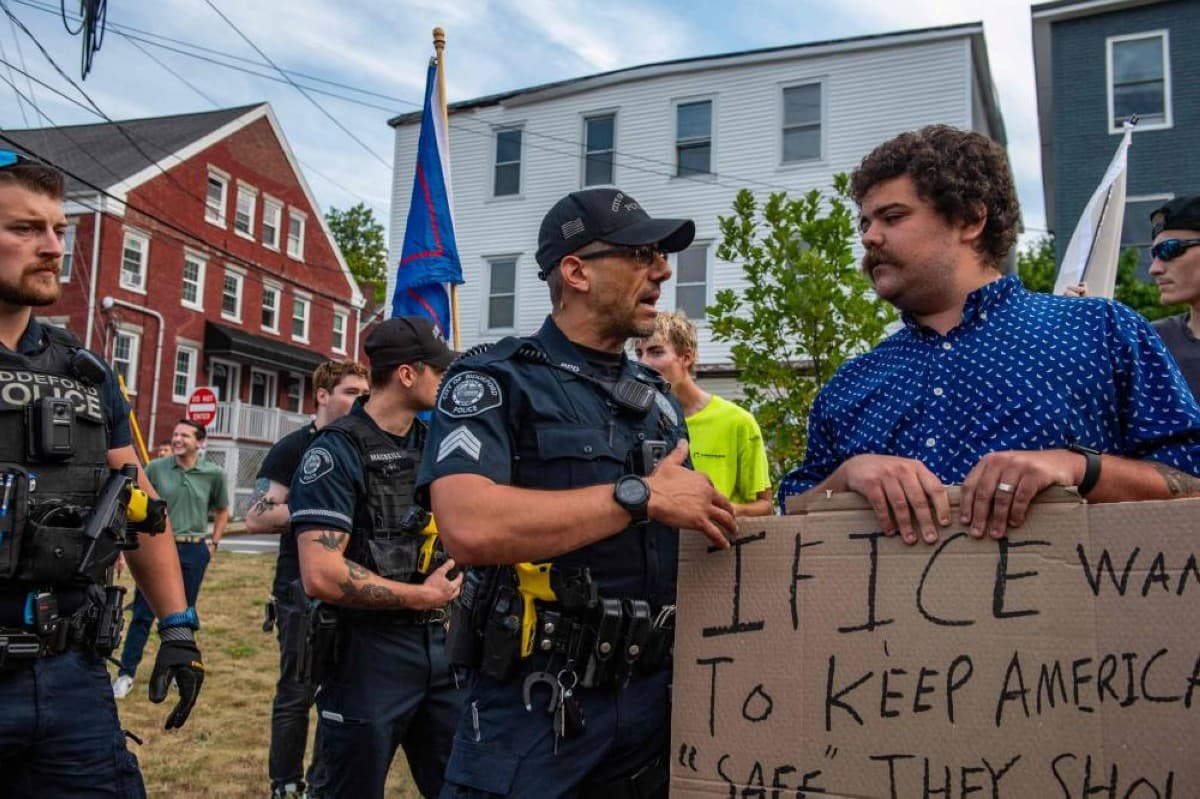 ICE agents in tactical gear conduct an enforcement operation on a residential street in Biddeford, Maine, where a 26-year-old Colombian man was fatally shot.
