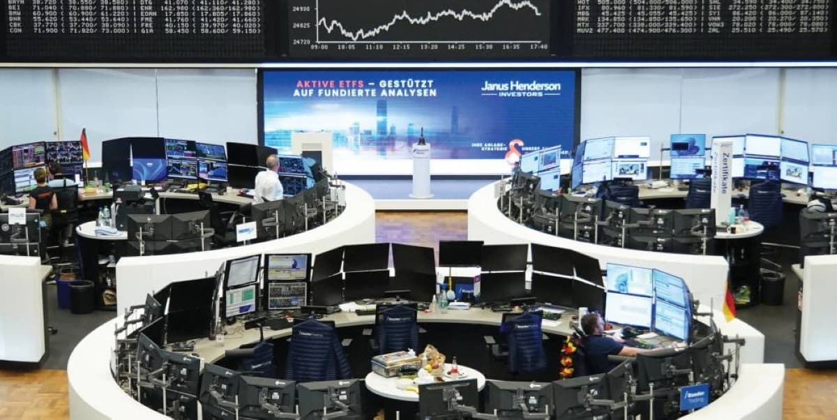 European stock exchange trading floor with digital screens displaying falling market indices amid Middle East tensions.