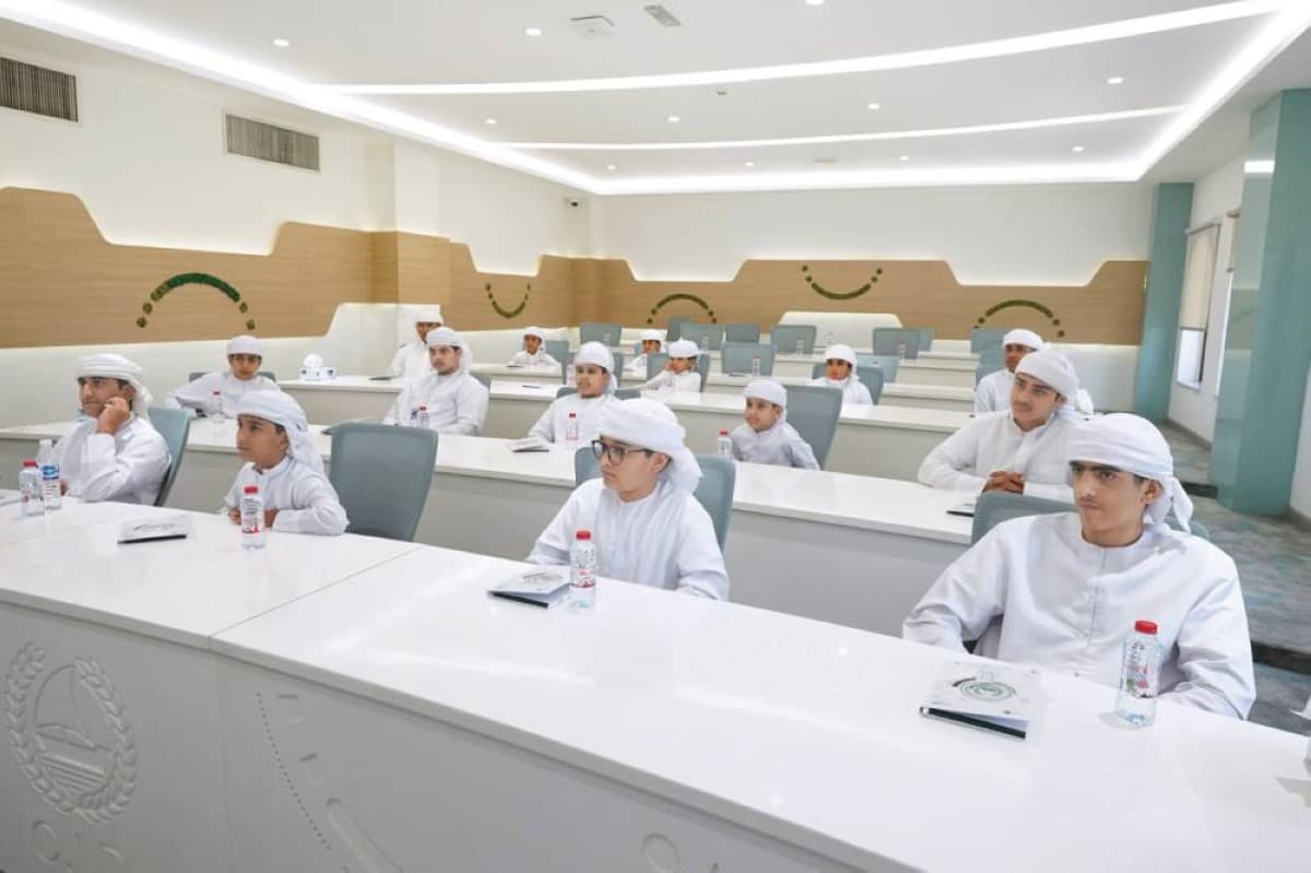 Dubai Police officers supervising students participating in the 'Promising Detective' summer course at a training facility in Dubai.