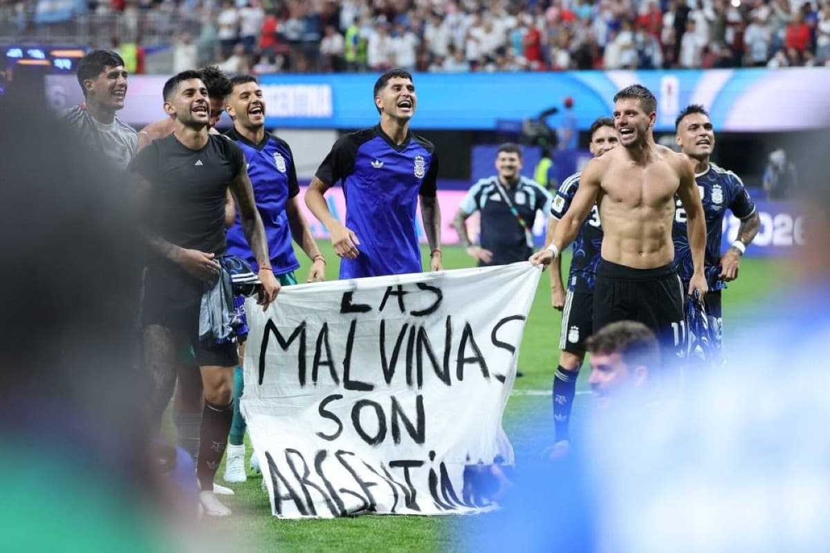 Argentina players hold up a banner reading 'Malvinas Argentinas' on the pitch at the Mercedes-Benz Stadium in Atlanta following their 2-1 semi-final victory over England.
