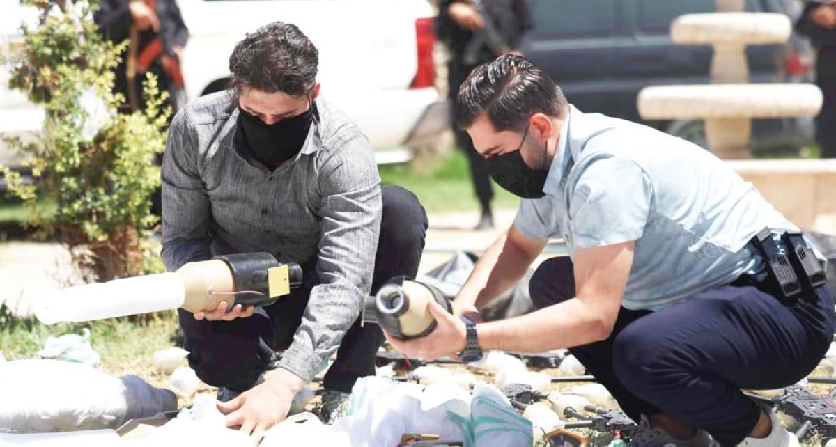 Syrian border security forces inspect a seized weapons shipment intercepted at the Al-Tanf border crossing with Iraq.