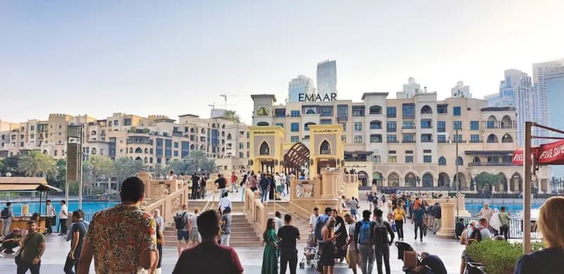 A luxury five-star resort on Palm Jumeirah in Dubai with pools and recreational facilities bustling with weekend visitors.