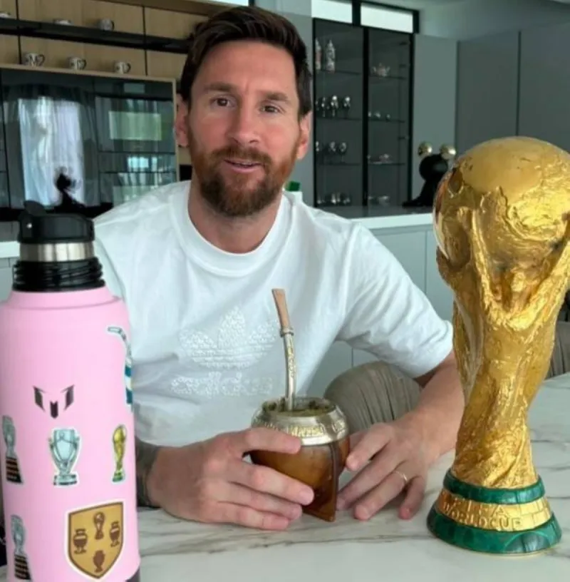 Lionel Messi holding a traditional mate cup and metal bombilla straw, a ritual he has made iconic at World Cup tournaments.