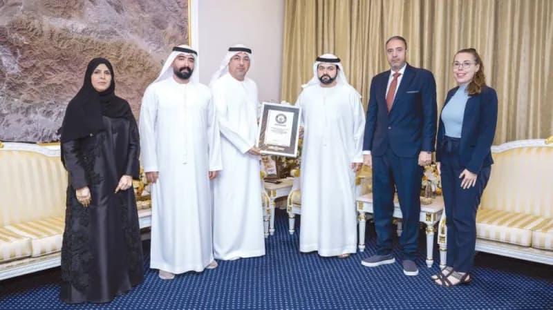 Sheikh Mohammed bin Hamad Al Sharqi, Crown Prince of Fujairah, receiving the Guinness World Records certificate for Music Street alongside the Fujairah Academy of Fine Arts team.