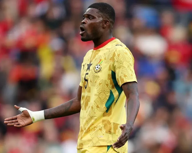 Thomas Partey in action on the football pitch, wearing Ghana's national team kit.