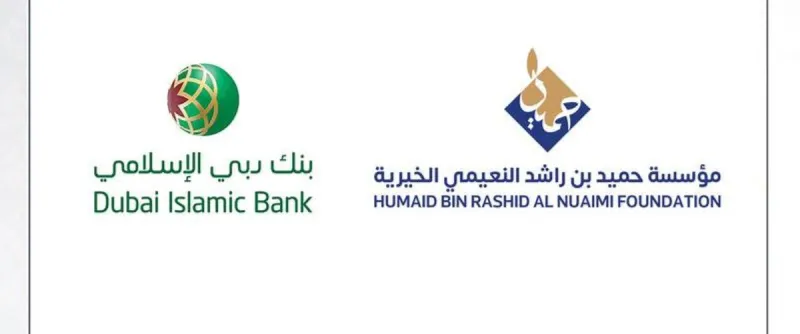 A representative of Dubai Islamic Bank presents a cheque of AED 8 million to officials of the Humaid bin Rashid Al Nuaimi Charitable Foundation.