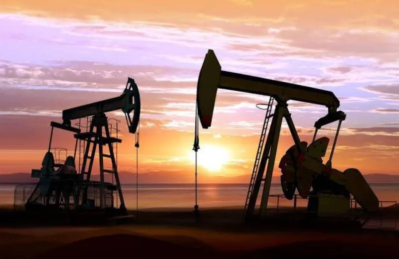 Oil storage tanks and infrastructure representing falling crude prices amid a US-Iran ceasefire deal.