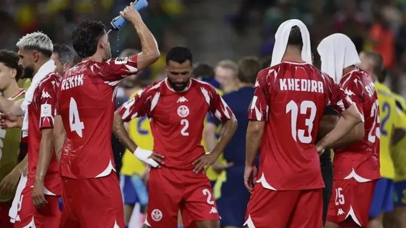 Players pause during a World Cup match to take a mandatory water break amid high temperatures.
