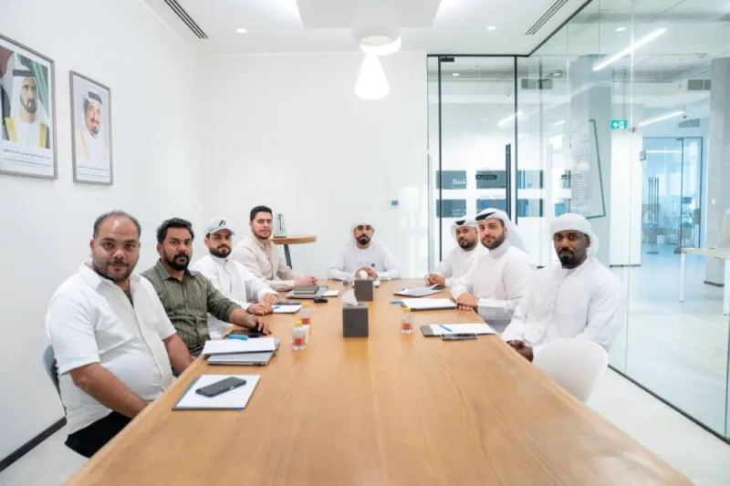 Members of the Quattro Sports Centre organising committee seated at a meeting table in Ajman during preparations for the Gulf Quattro 2026 football festival.