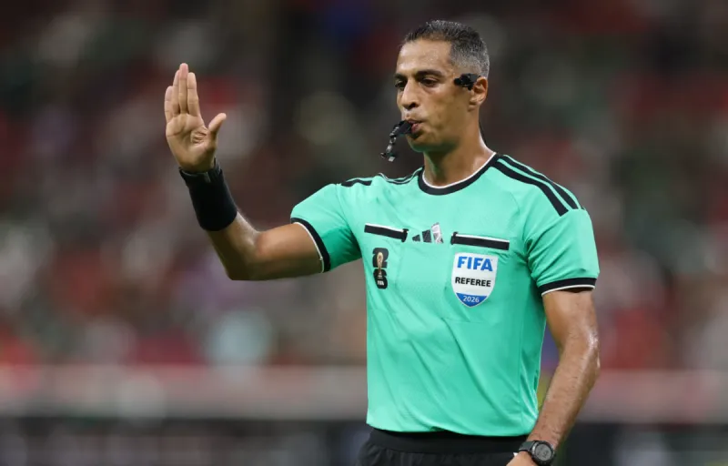Egyptian referee Amin Omar on the pitch during a World Cup 2026 group stage match in Texas.