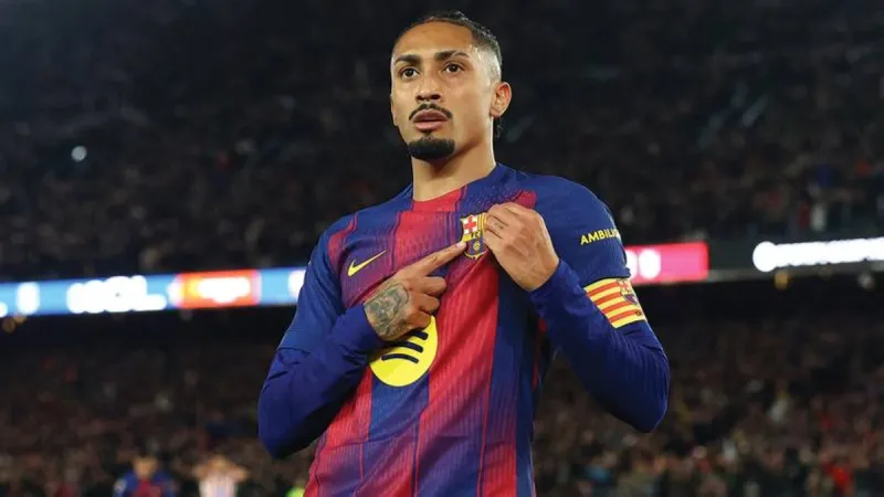 Brazilian footballer Raphinha in Barcelona's blue and red kit during a match.