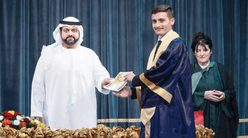 Sheikh Mohamed bin Hamad bin Mohammed Al Sharqi, Crown Prince of Fujairah, presenting graduation certificates to students at the Fujairah Private Academy secondary school graduation ceremony.