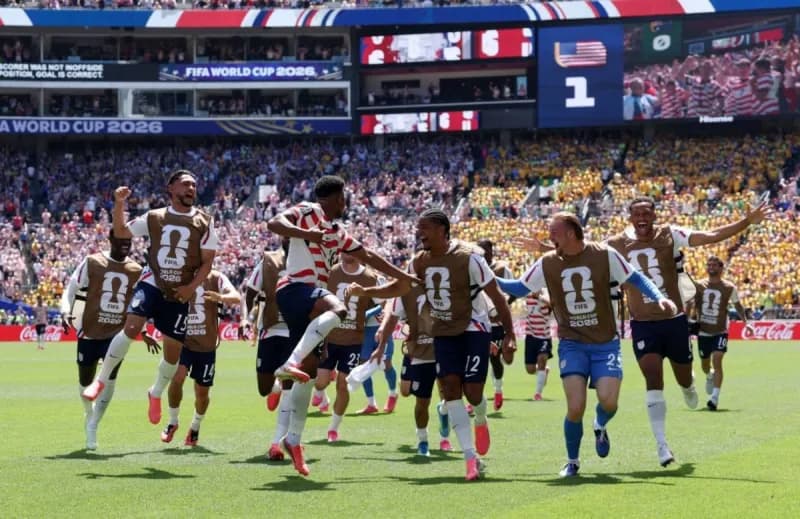 American fans celebrating in Seattle's stadium after the US national team's 2-0 victory over Australia at the 2026 World Cup.