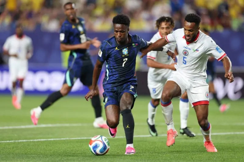 A football match in progress at the 2026 FIFA World Cup, with players competing on the pitch during an action-filled game.