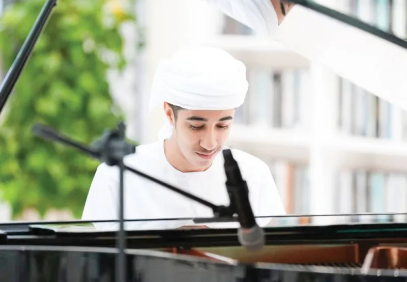 Young Emirati pianist Ahmed Al Hashmi performing at the piano during a World Music Day event at the Mohammed bin Rashid Library.
