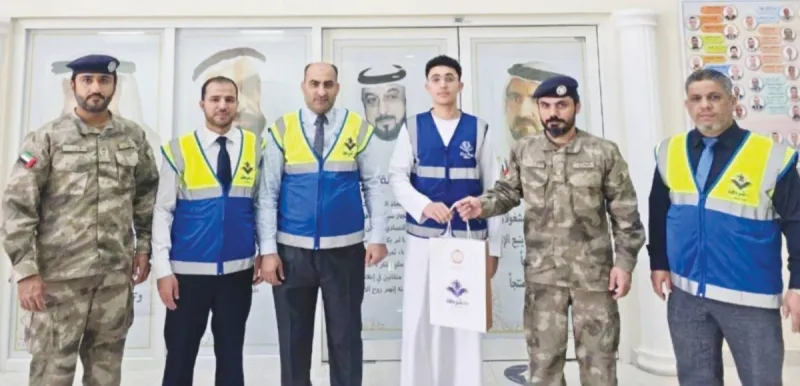 Abu Dhabi Police officials honouring student volunteers Fahad Mahmoud Al Hamadi and Mohammed Mustafa Hamdan from Al Falah School at a ceremony recognising their achievement in the Arab Reading Challenge.