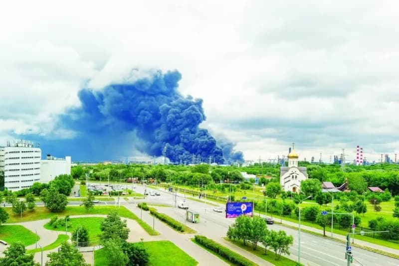 Aerial view of fire and smoke rising from a struck energy or oil facility in the context of the Russia-Ukraine conflict.