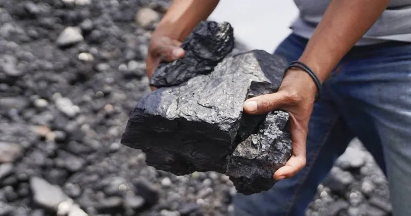 A historical illustration or photograph depicting coal mining operations during the Industrial Revolution era.