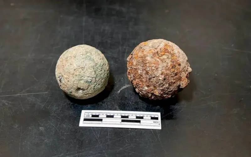 An intact iron cannonball recovered from an archaeological excavation at the historic Alamo site in Texas.