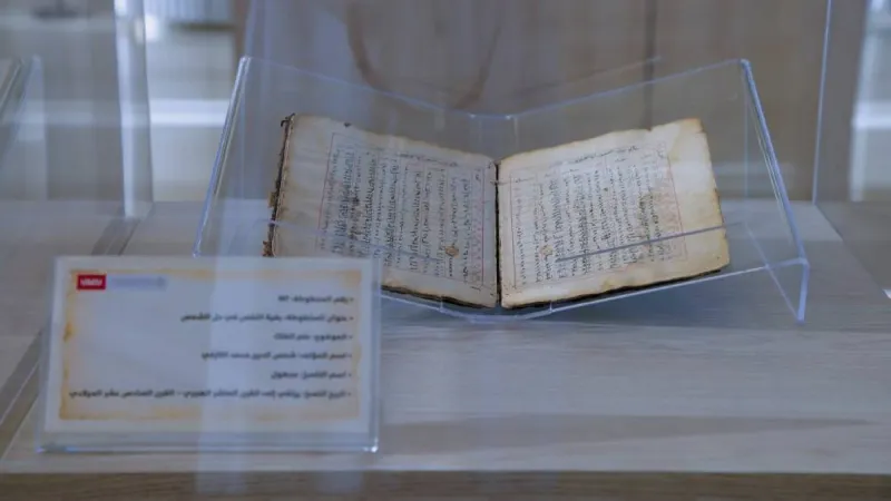 A visitor examines rare historical Arabic manuscripts on display at the 'Manuscripts: Identity and Sustainable Development' exhibition held at UAE University in cooperation with Bait Al Hikma.