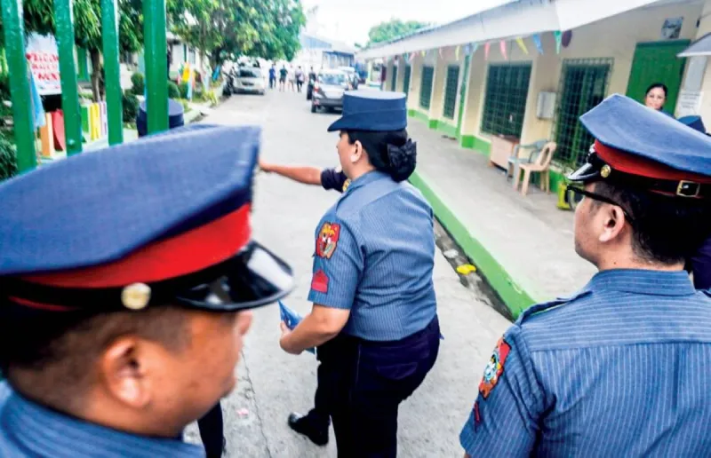 Philippine police officers at the scene of the school shooting at San Jose National High School in Tacloban city.