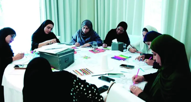 A training workshop session on art therapy organised by the Dubai Foundation for Women and Children, with participants engaging in expressive arts activities.