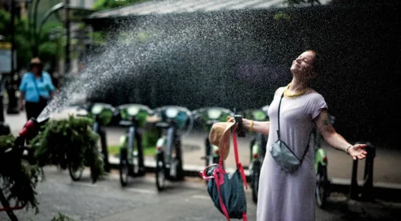 Crowds of tourists outside the Eiffel Tower in Paris during a severe European heatwave.