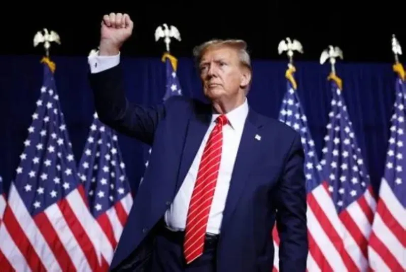 President Donald Trump addresses a large crowd at a political rally.