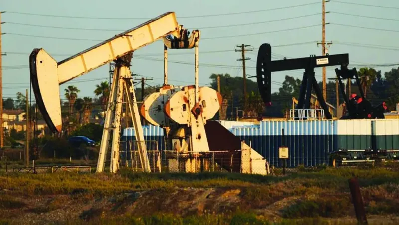 Oil storage tanks and tanker vessels reflecting the current oversupply pressures weighing on global crude markets.