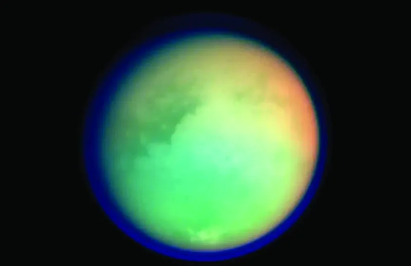 An illustration or image of Titan, Saturn's largest moon, with its hazy atmosphere and surface features visible.