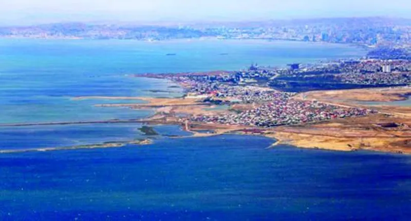 An aerial or shoreline view of the receding waters of the Caspian Sea, the world's largest enclosed body of water, showing dried or exposed shoreline.