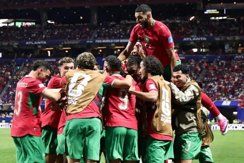 Morocco players celebrate after qualifying for the round of 32 at the 2026 FIFA World Cup following their 4-2 victory over Haiti.