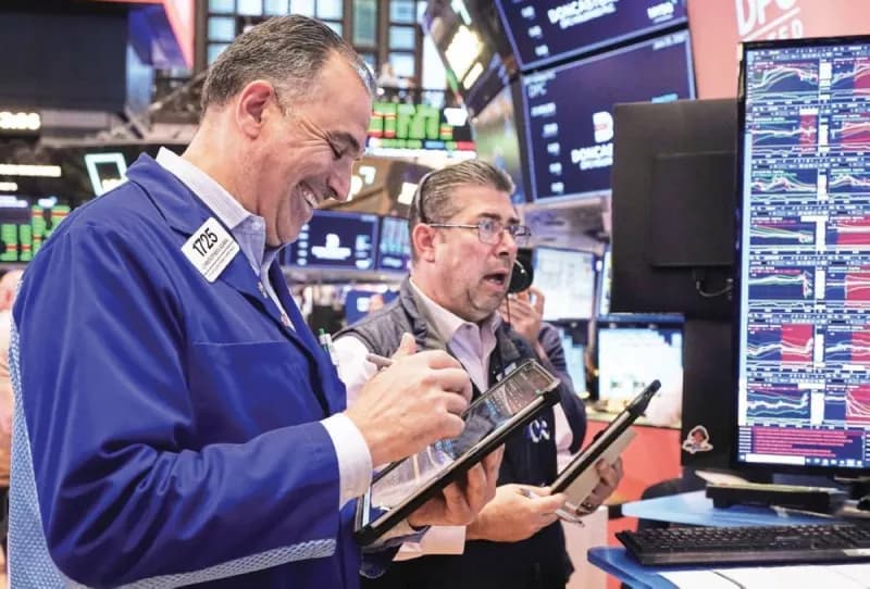 Stock market screens showing rising indices driven by artificial intelligence investment optimism following Micron Technology's strong earnings results.