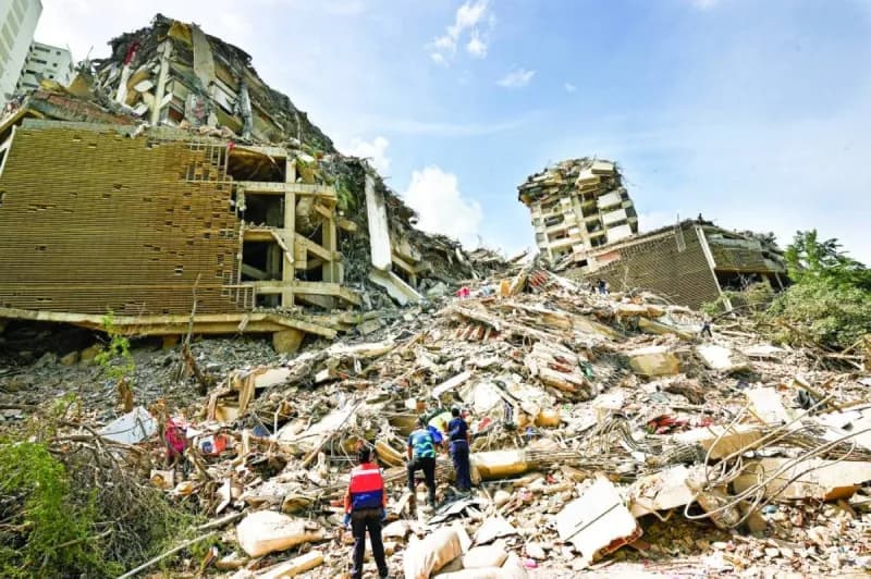 Rescue workers search through rubble of collapsed buildings in Caracas following two powerful earthquakes that struck Venezuela.