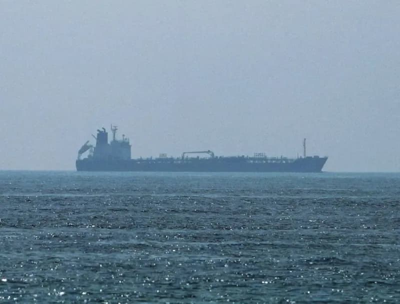 A cargo vessel transits the Strait of Hormuz amid heightened security tensions following drone attacks attributed to Iran.