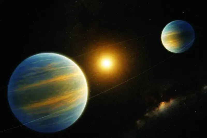 An artist's illustration of two giant low-density exoplanets orbiting a distant star approximately 1,100 light-years from Earth.