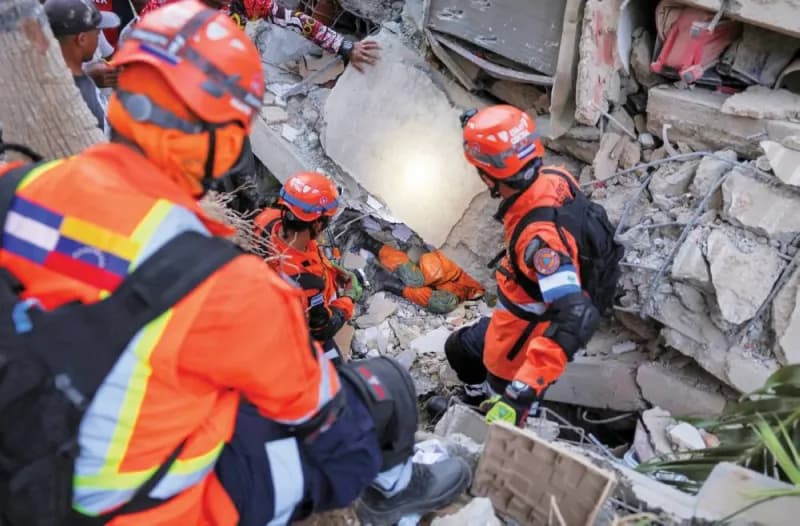 Rescue workers and residents searching through the rubble of collapsed buildings in La Guaira, Venezuela, following two powerful earthquakes.