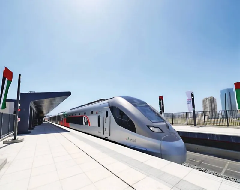 A passenger train on the Etihad Rail network preparing to depart from a UAE station.