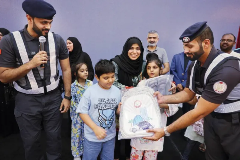Abu Dhabi Police officers at a community traffic awareness event for Asian communities at Abu Dhabi Sports Club.