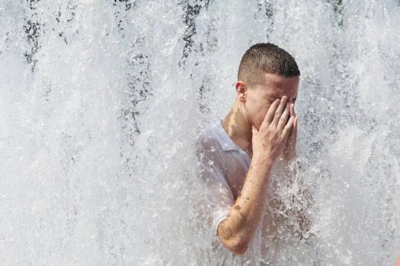 Emergency services personnel and members of the public seek relief from the intense heatwave gripping central Europe, as France begins tallying heat-related deaths.
