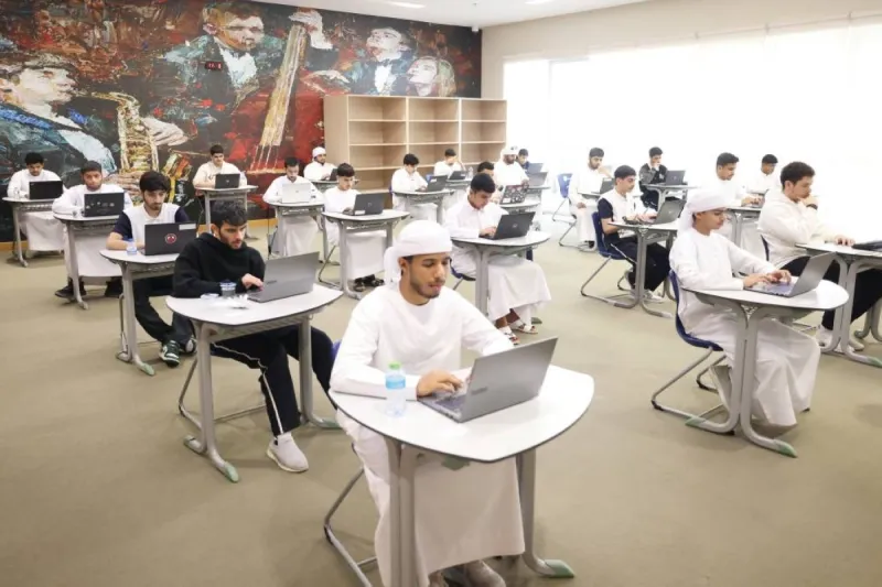 Grade 12 students walking out of a physics exam at a UAE school after completing their test.